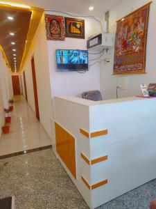 a hospital room with a sink and a tv on the wall at Shivam Guest House 10 mint walking from Ram Janam Bhumi in Ayodhya