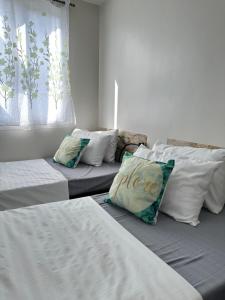 a room with two beds with white sheets and pillows at Casa Mia at SMDC Styles Residence Tower A in Iloilo City