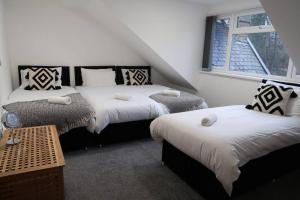 a bedroom with two beds and a window at Two-Bedroom Apartment with Scenic Balcony View in Shipley