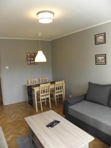 a living room with a couch and a table at Apartament „STARY RYNEK” Słupsk in Słupsk