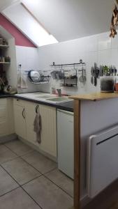 a kitchen with a sink and a counter top at Appartement loft. A 2km de la colline d'Elancourt in Trappes