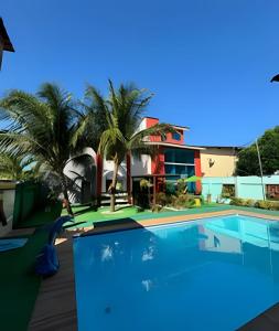 a swimming pool in front of a house at Pousada e Restaurante Mar dos Sonhos in Paripueira