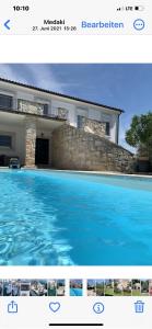 a picture of a house and a swimming pool at Villa Palma in Linz