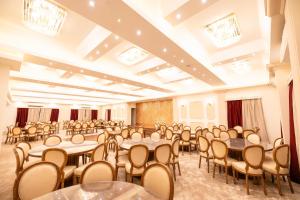 a large room with tables and chairs in it at Mar Charbel Hotel Cairo in Cairo