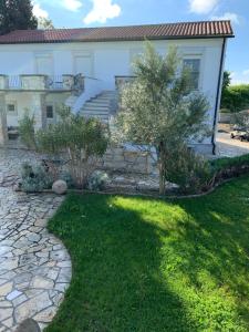 a house with a stone walkway in front of a yard at Villa Palma in Linz