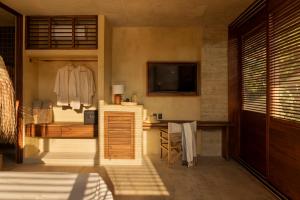 a bedroom with a bed and a desk and a television at Ennea Hotel - Adults Only in Puerto Escondido
