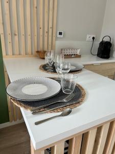 a table with plates and wine glasses on it at Terasse avec superbe vue sur le marché de Dieppe in Dieppe