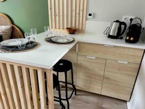 a kitchen with a table with wine glasses on it at Terasse avec superbe vue sur le marché de Dieppe in Dieppe