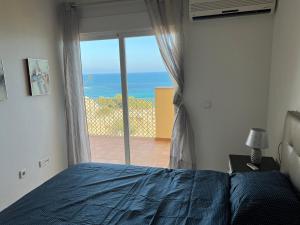 A bed or beds in a room at First Line Cabo Roig Orihuela Costa