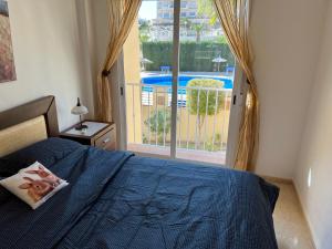 A bed or beds in a room at First Line Cabo Roig Orihuela Costa