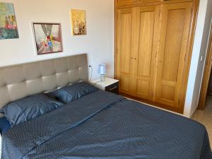 A bed or beds in a room at First Line Cabo Roig Orihuela Costa