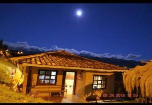 a small house with the moon in the sky at Hospedaje Leonor in Cuenca