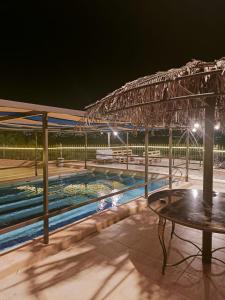 a patio with a swimming pool at night at شاليه للايجار اليومي والاسبوعي in Amman