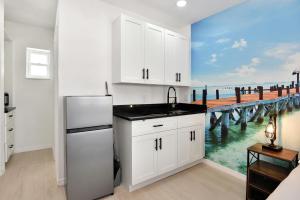 a kitchen with a refrigerator and a pier at Blue Mist Motel - Room # 5 in Daytona Beach