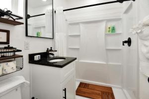 a white bathroom with a sink and a shower at Blue Mist Motel - Room # 5 in Daytona Beach