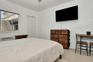 a bedroom with a bed and a television on a wall at Blue Mist Motel - Room # 5 in Daytona Beach +1 photo