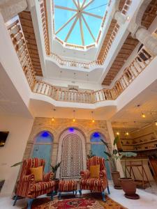 a room with two chairs and a ceiling at Riad Al Manara in Essaouira