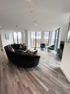 a large living room with a large couch and chairs at Opulent 3 -Bedroom Penthouse with Stunning Views in Newcastle upon Tyne
