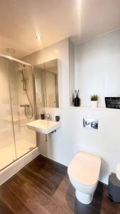 a bathroom with a toilet and a sink and a shower at Opulent 3 -Bedroom Penthouse with Stunning Views in Newcastle upon Tyne