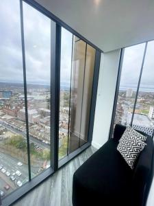 a room with a chair and a large window at Opulent 3 -Bedroom Penthouse with Stunning Views in Newcastle upon Tyne