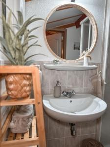 a bathroom with a sink and a mirror at Boho Beach House De Haan in De Haan +23 photos