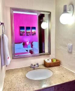 a bathroom with a sink and a large mirror at Hotel Barranquilla in Campeche
