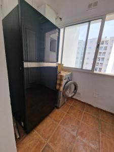 a bathroom with a washing machine in a room with windows at Dar Salem III in Tunis