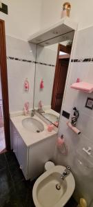 a bathroom with a sink and a toilet and a mirror at Villa Angel in Rapallo