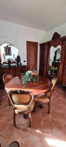 a dining room table with chairs and a mirror at Villa Angel in Rapallo