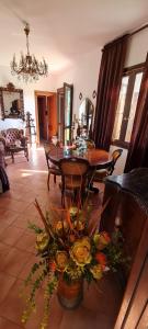 a living room with a dining room table and flowers at Villa Angel in Rapallo