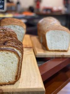 two slices of bread sitting on wooden cutting boards at Hotel Aranjuez in San José