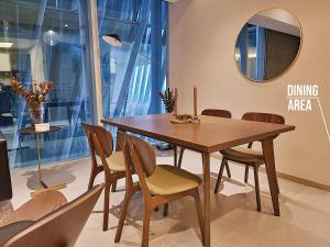 a dining area with a wooden table and chairs at Luxury Condo Paradox Santa Fe By Bamboo Skylife in Mexico City