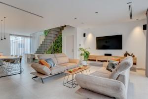 a living room with two couches and a tv at Green House - Modern Villa in Tenerife, Spain in Guía de Isora