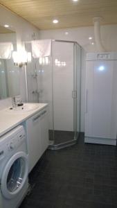a bathroom with a washing machine and a shower at Ruka Chalets Royal Apartments in Ruka +31 photos