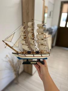a person holding a model ship in a room at Apartment Irena in Jadranovo