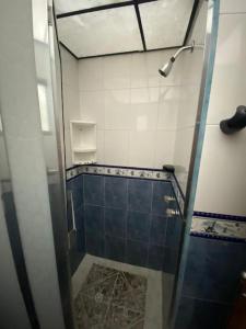 a shower with a glass door in a bathroom at Santamaria Lago Home in Bogotá