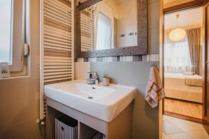 a bathroom with a sink and a mirror at Apartment KIM in Umag +19 photos