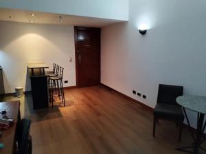 an empty room with chairs and a table and a counter at Bonaparte Hotel Flat Particular in Brasília