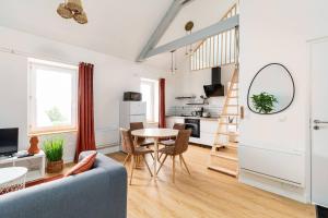 ein Wohnzimmer mit einem blauen Sofa und einem Tisch in der Unterkunft Le Aristide - Centre Ville - Calme - Terrasse in Saint-Nazaire + 20 Fotos