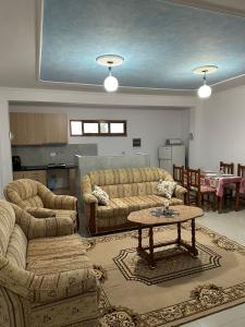 a living room with two couches and a table at Gafko Apartments Durres in Durrës