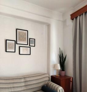 a living room with a couch and pictures on the wall at Varosi Apartment in Komotini