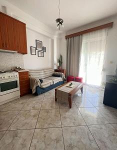 a living room with a couch and a table at Varosi Apartment in Komotini