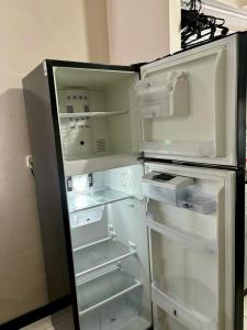 an empty refrigerator with its door open in a kitchen at Apartamento totalmente equipado a 5 minutos del Parque del Café - Montenegro in Montenegro