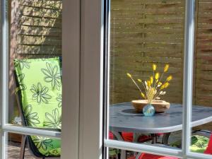a table with a vase on it on a patio at Ferienwohnung STRANDGUT in Behrensdorf