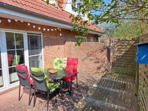 a table and chairs sitting on a patio at Ferienwohnung STRANDGUT in Behrensdorf +8 photos