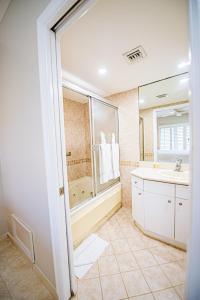 a bathroom with a tub and a sink at Seven Mile Beach Resort in George Town +111 photos