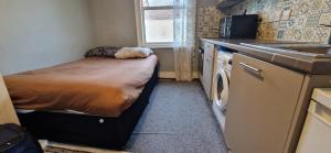 a small room with a bed and a sink at 29 tynemouth road in London