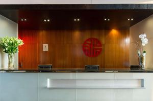 a lobby with a counter and a red sign on the wall at NH Collection Mexico City Santa Fe in Mexico City