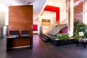 an office with two monitors on a desk and a staircase at NH Collection Mexico City Santa Fe in Mexico City