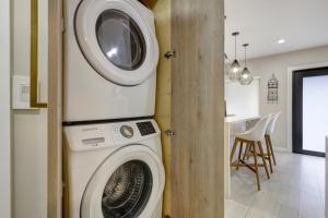 a washer and dryer in a room with a kitchen at Designer Home w Pool & Firepit - 7 min to Brickell in Miami